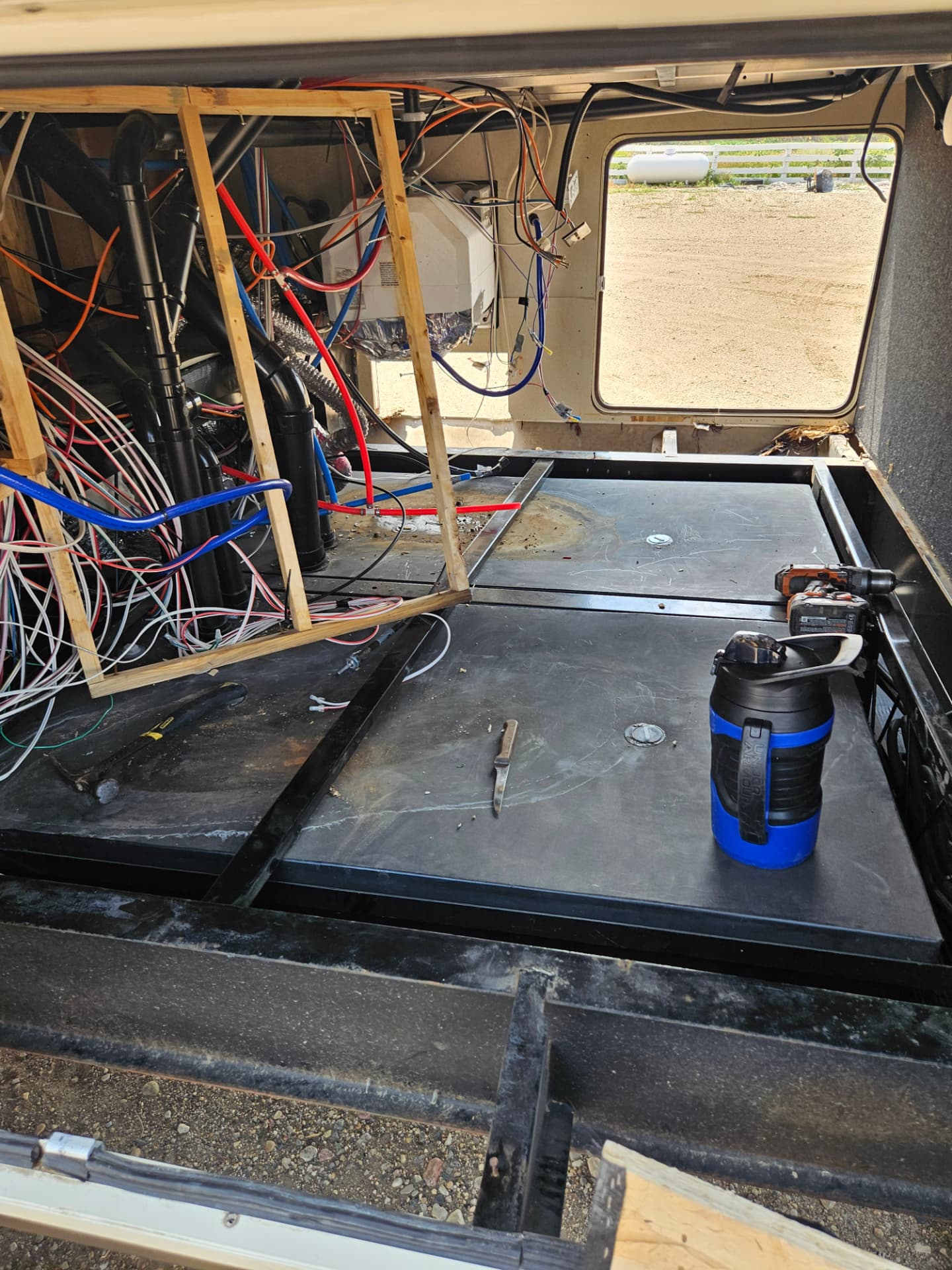 Camper Care performing mobile RV repair work on a slide-out and underbelly at a customer's site