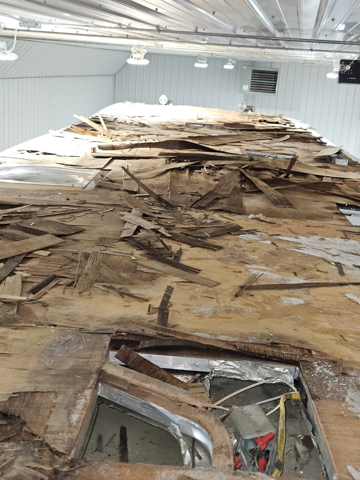 RV roof torn down to the framing inside the shop