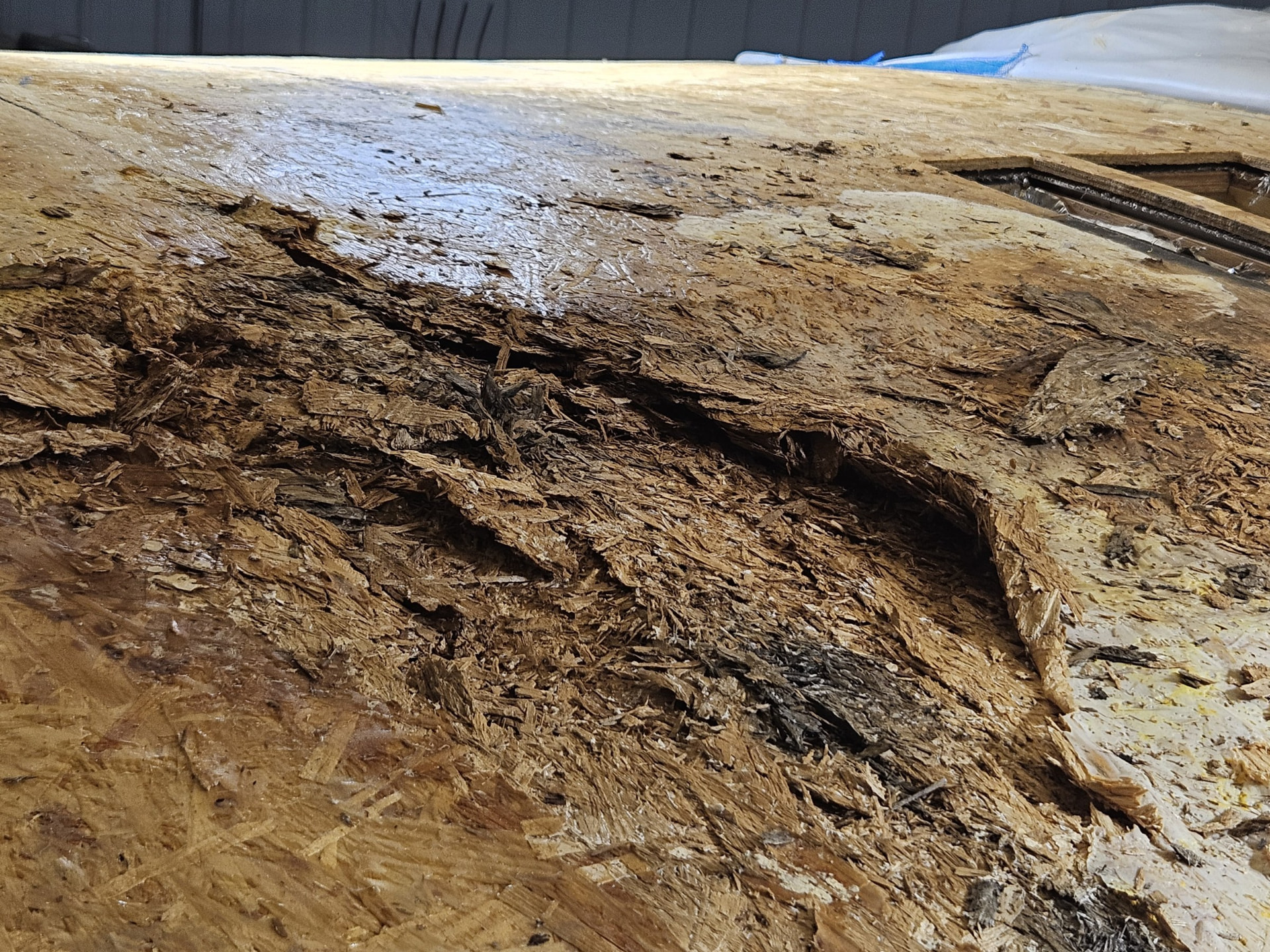 Torn-off RV roof showing rotted decking before rebuild