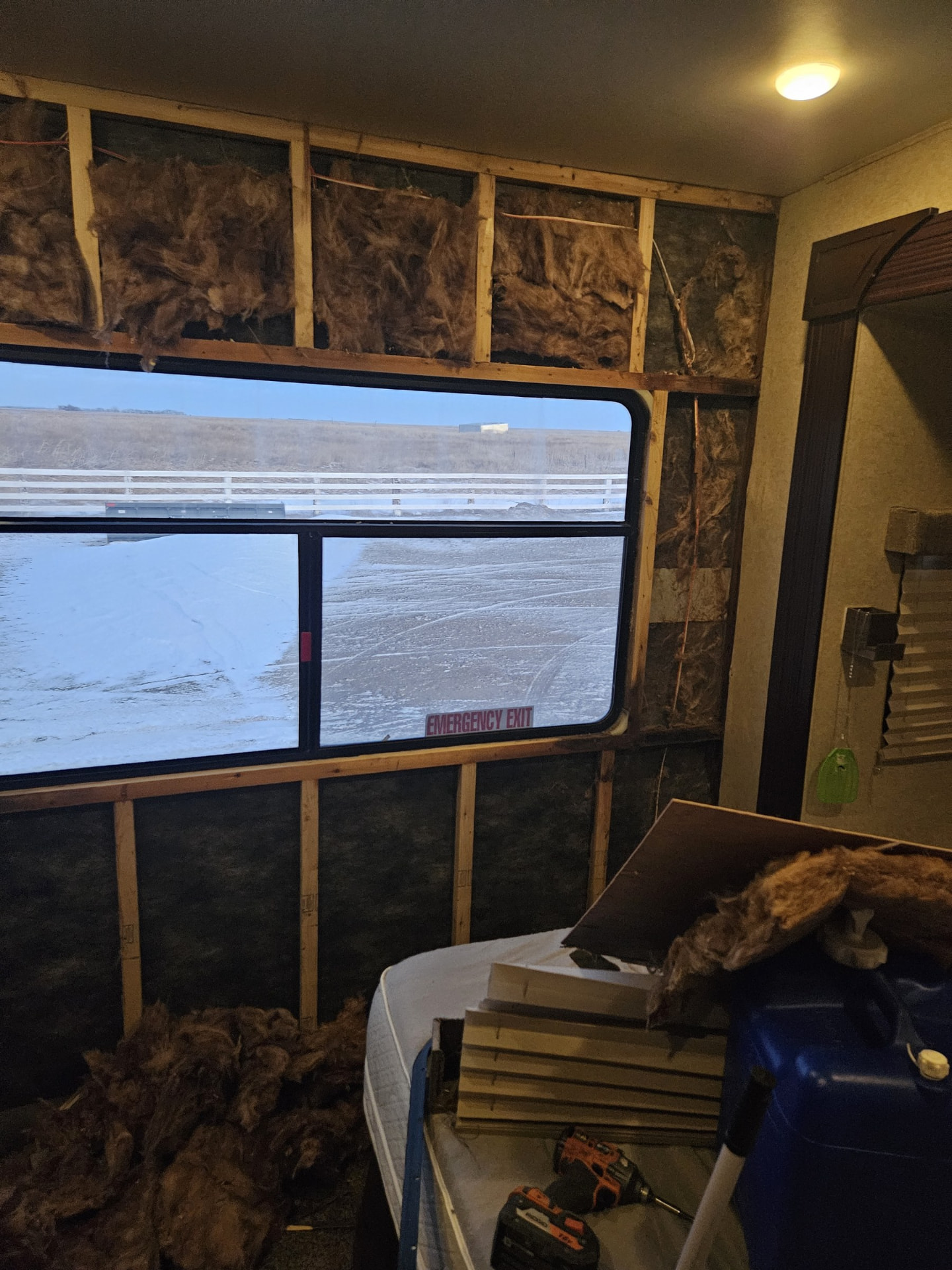 RV bedroom wall stripped to studs and insulation