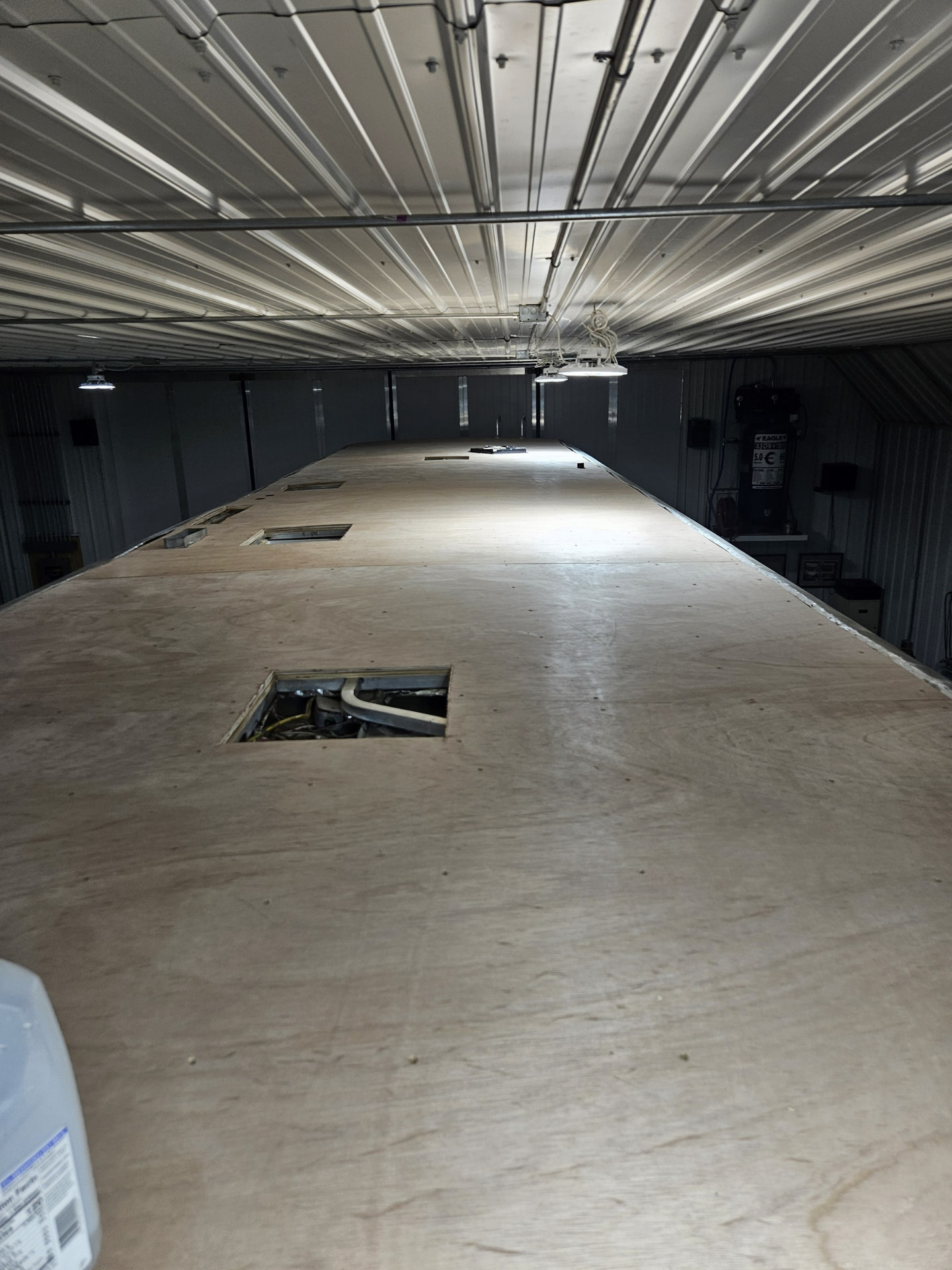 Fresh plywood decking laid across a full RV roof