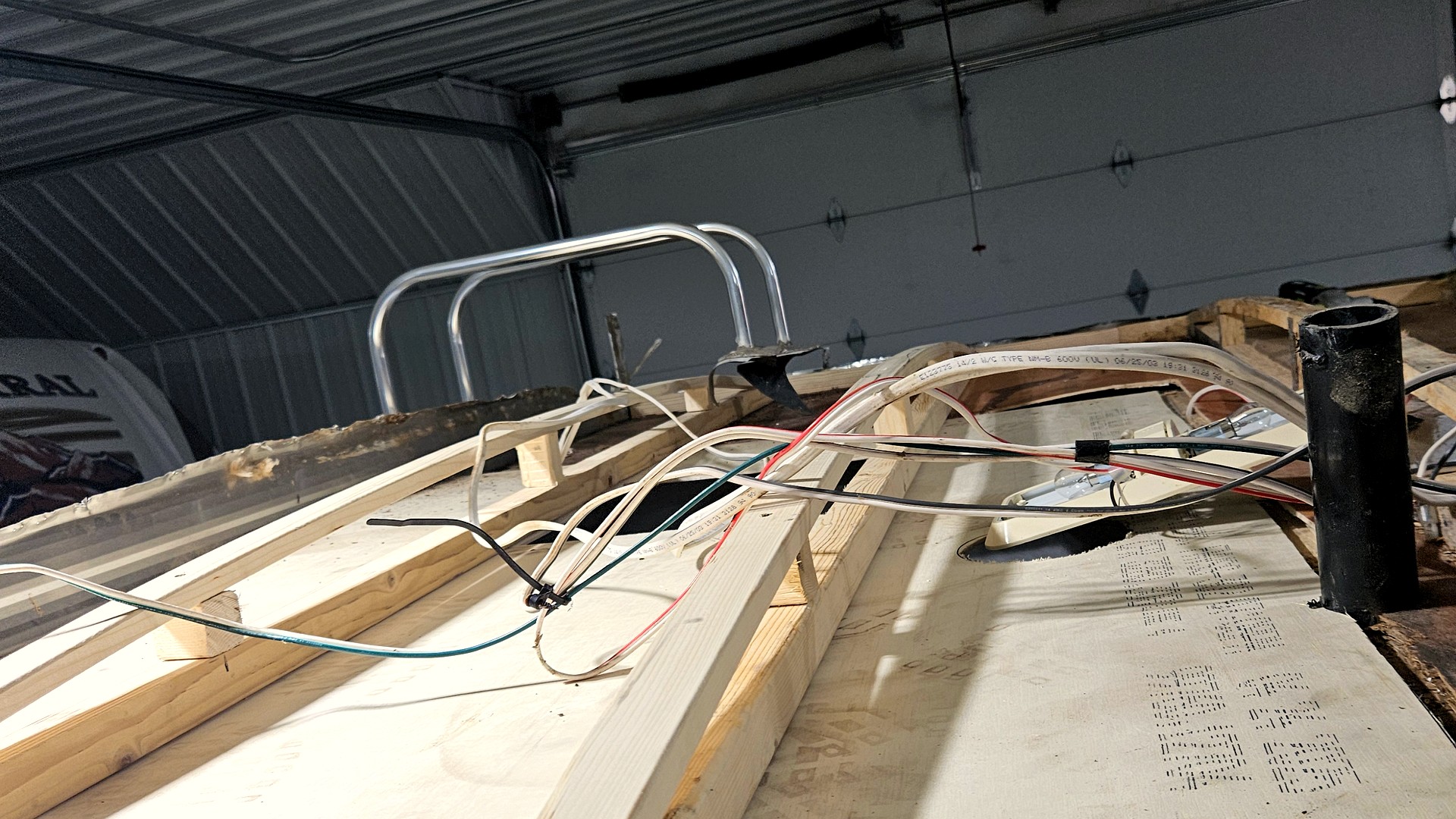 Fresh insulation laid between new camper roof rafters